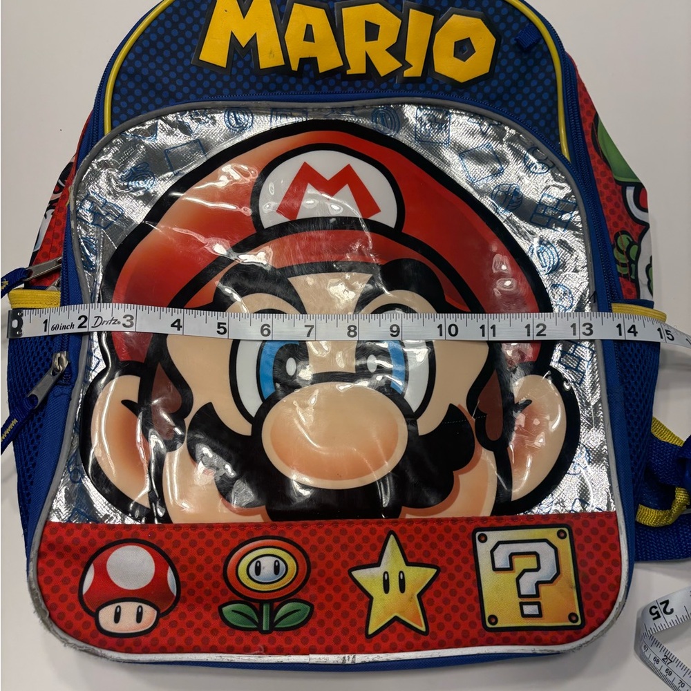 MARIO BACKPACK 14” LONG by 16” LONG
2 ZIPPER POUCHES 2 MESH SIDE POCKETS